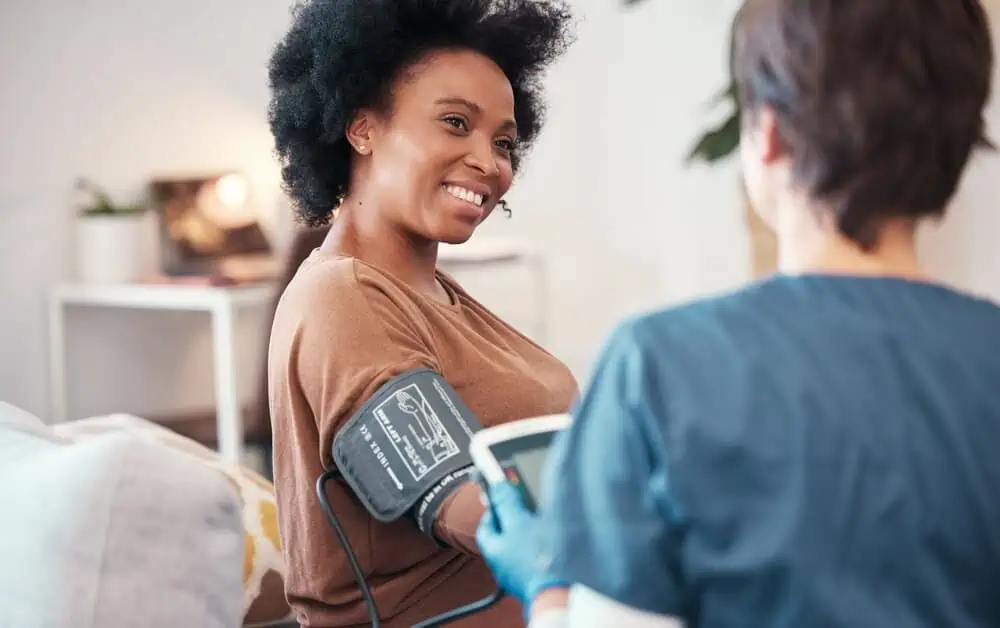 A medical professional takes the blood pressure of a patient - discount health membership