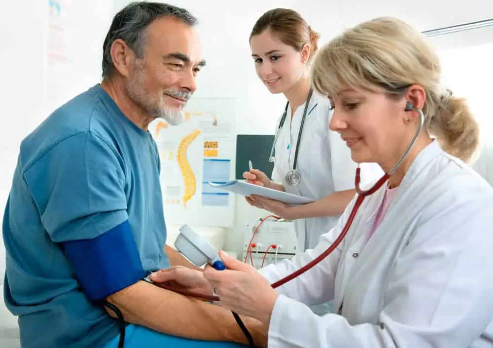 A doctor measuring a patient’s blood pressure